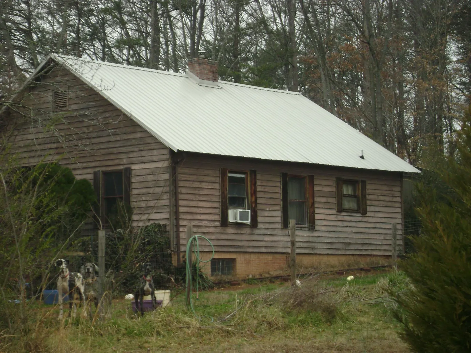 White metal roof on an old wood sided farmhouse, from a Metal Roof Installation job in Warsaw